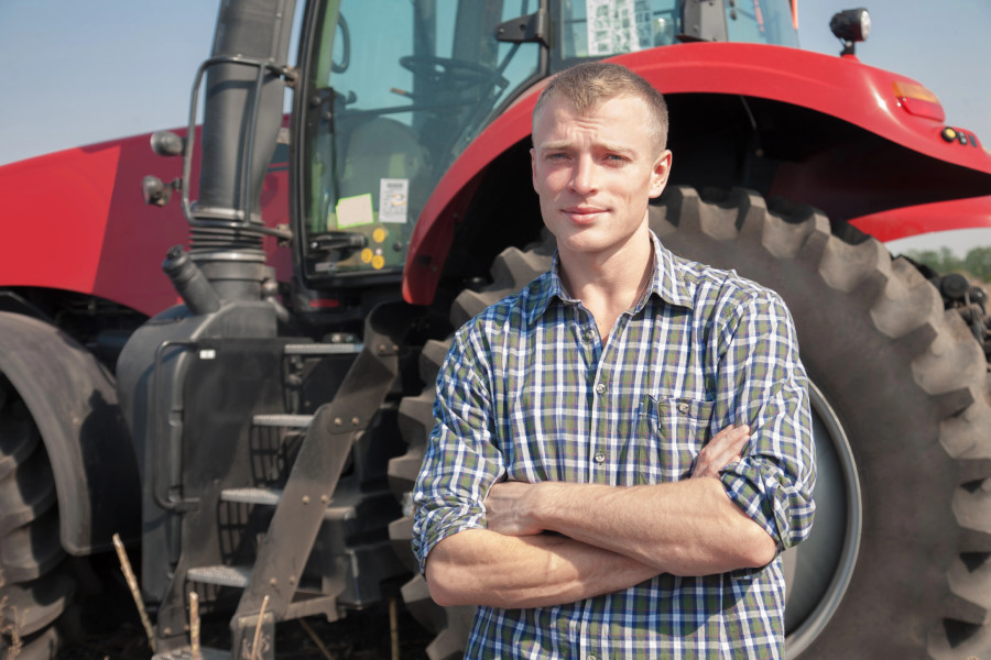 farmer in front of new tractor