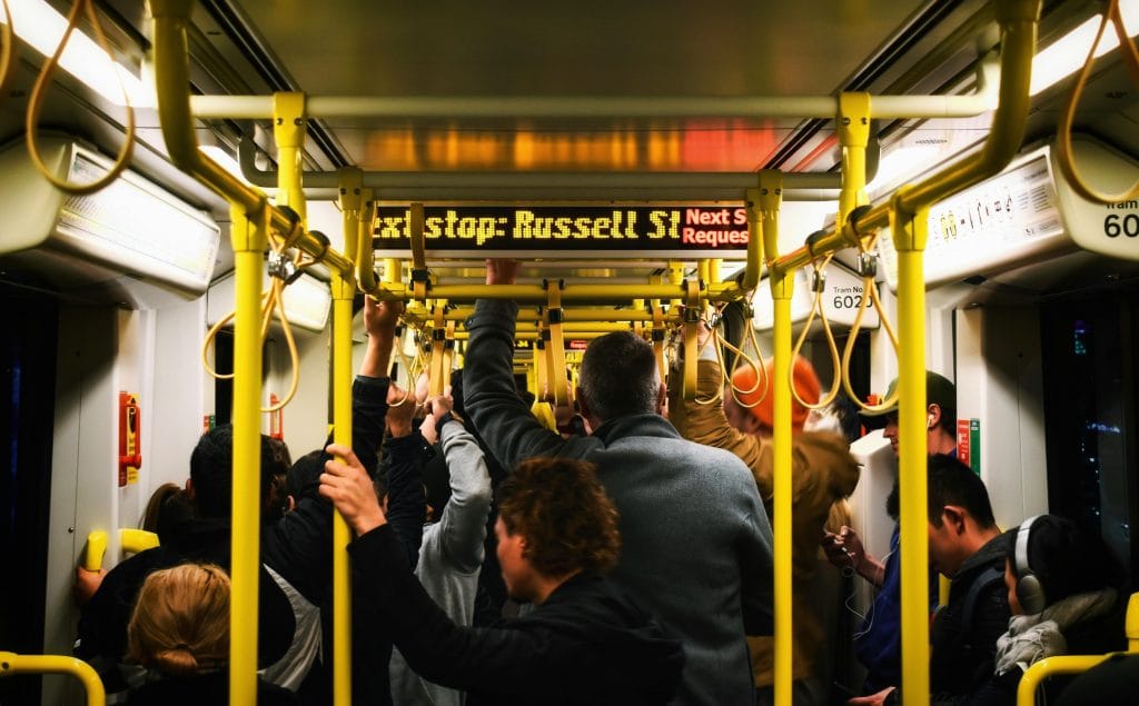 Morning commuters standing inside a Melbourne tram during peak hour.
