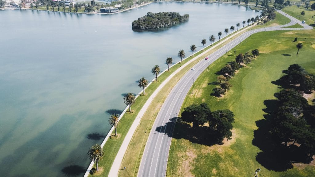 Aerial view of Albert Park Lake and surrounding South Melbourne apartments and parkland near the Melbourne CBD