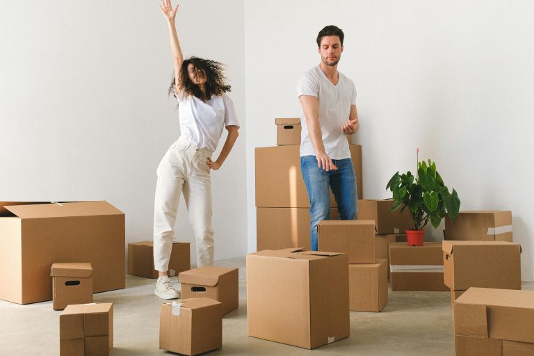 Young couple unpacking moving boxes in their new Tarneit family home